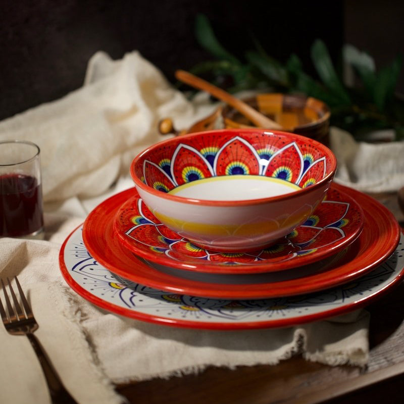Ceramic tableware set with colorful patterns on a wooden table.