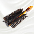 123 KOH-I-NOOR round styling hairbrush with brown tortoiseshell acetate handle and black boar bristles; KOH-I-NOOR's gold logo stamped on the handle