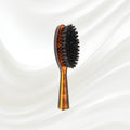203 KOH-I-NOOR small oval hairbrush with brown tortoiseshell acetate handle and black boar bristles; KOH-I-NOOR's gold logo stamped on the handle