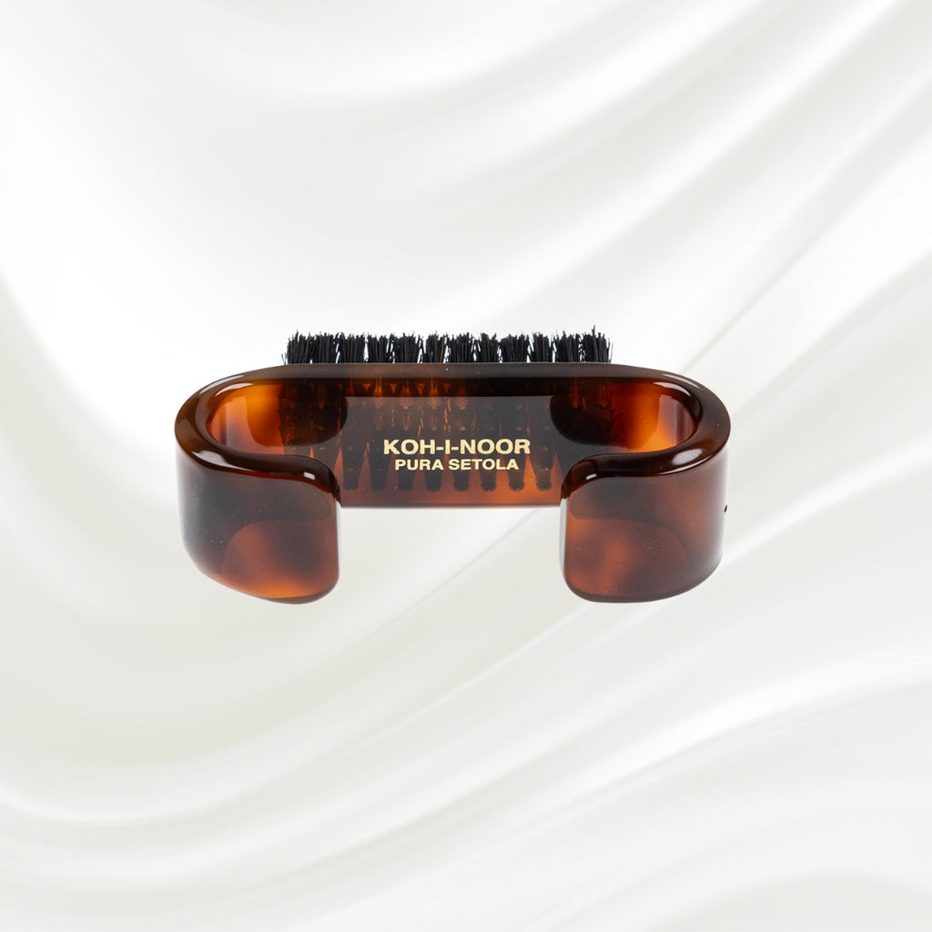 tortoiseshell nail brush with handle and black boar bristles. KOH-I-NOOR gold logo printed on the handle