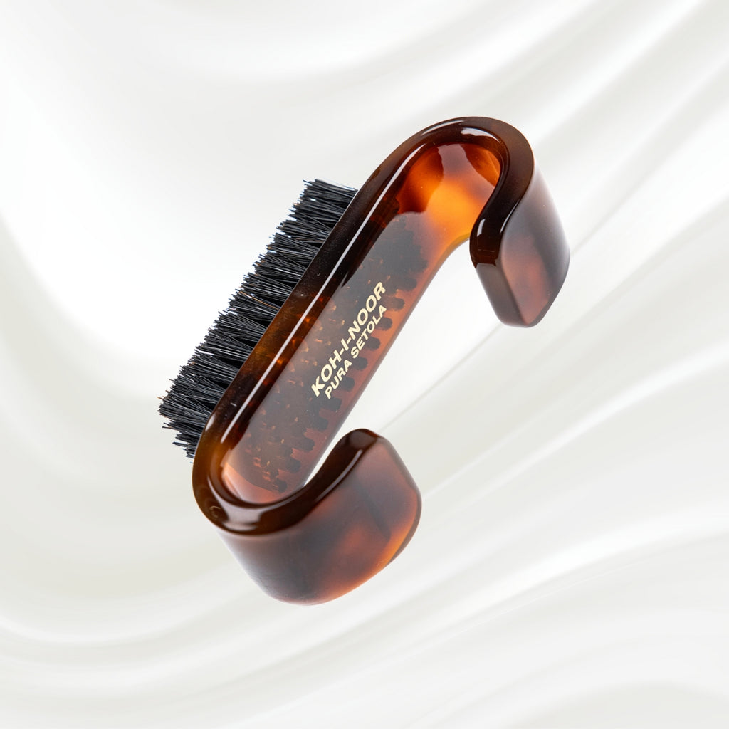 tortoiseshell nail brush with handle and black boar bristles. KOH-I-NOOR gold logo printed on the handle