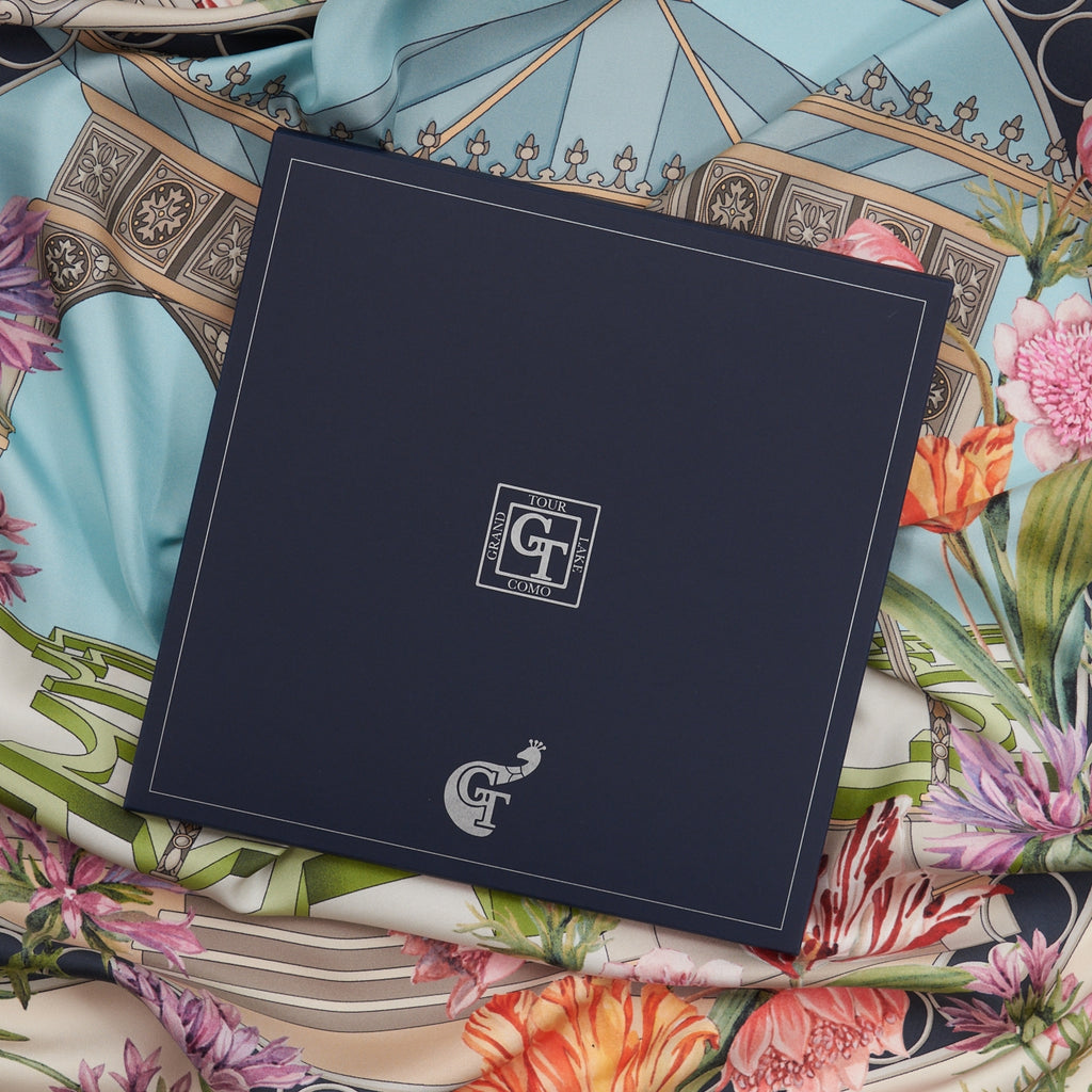 blue box on top of a colourful silk scarf