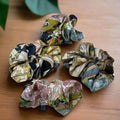 silk scrunchie with floral pink, black and blue patterns