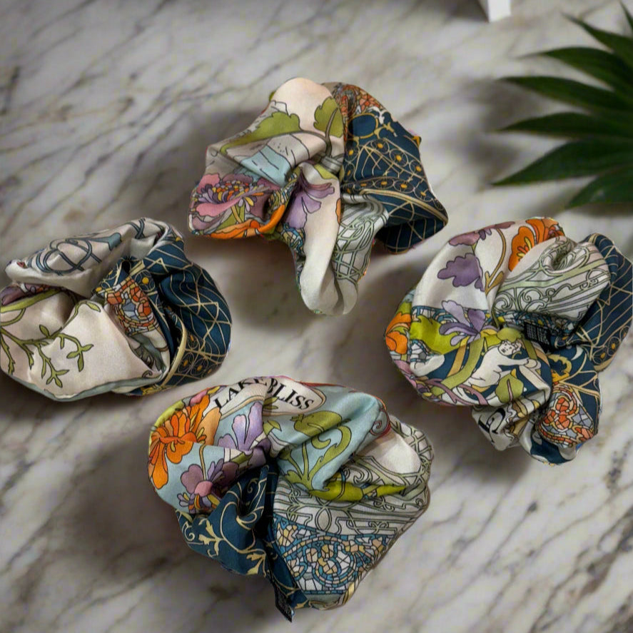 Lake Como Silk scrunchie on a marble background