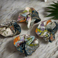 Lake Como Silk scrunchie on a marble background
