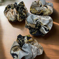 silk scrunchie with gold, black and blue gate designs