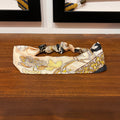 golden silk headband with mosaic and floral design