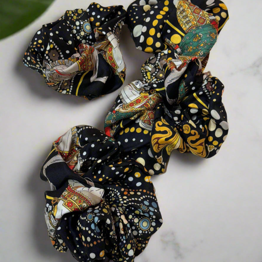 black silk scrunchie with white and gold round patterns