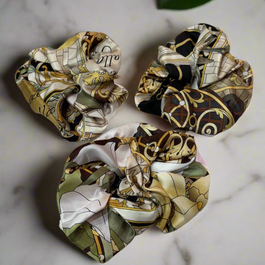 silk scrunchie with green, white and gold patterns