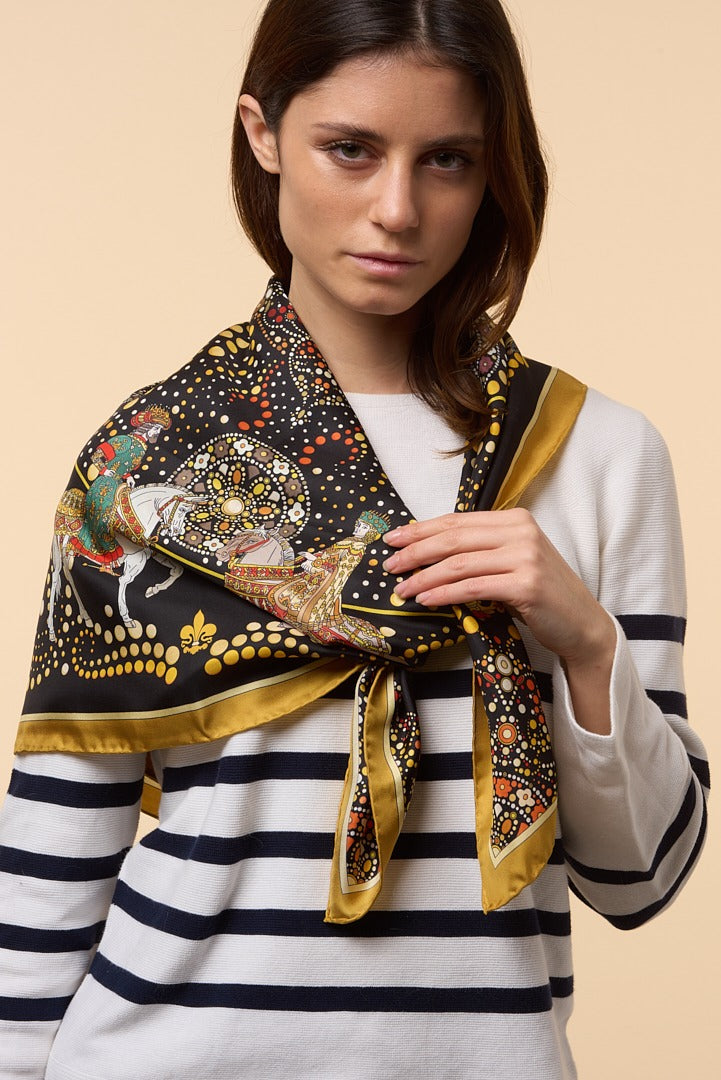 brunette woman wearing a striped shirt and a colourful silk scarf