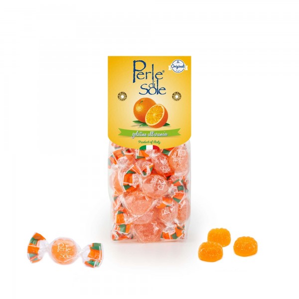 A clear plastic bag of Perle Sole orange-flavored candies with a yellow label, shown on a white background with three loose orange candies in front.