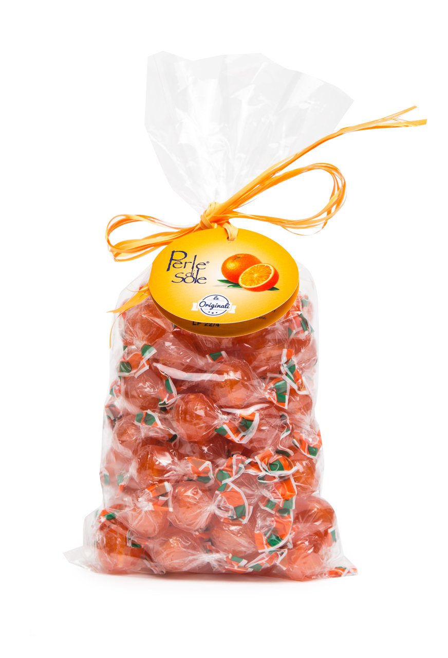 A clear cellophane bag filled with orange-red wrapped candies tied with a yellow-orange string, with a round yellow tag reading 'P. R.
