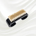 black nail brush with handle and natural bristles. KOH-I-NOOR logo printed on the handle