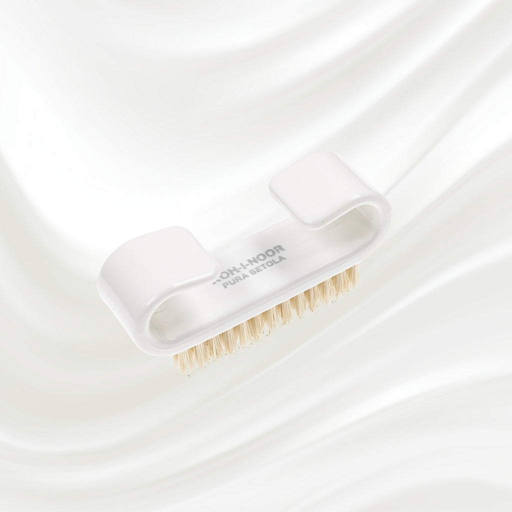 white nail brush with handle and natural bristles. KOH-I-NOOR logo printed on the handle