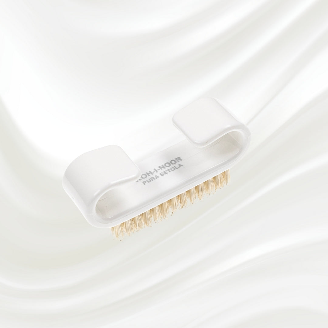 white nail brush with handle and natural bristles. KOH-I-NOOR logo printed on the handle