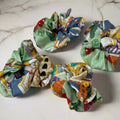 green silk scrunchie with cartoon design of the city of Como