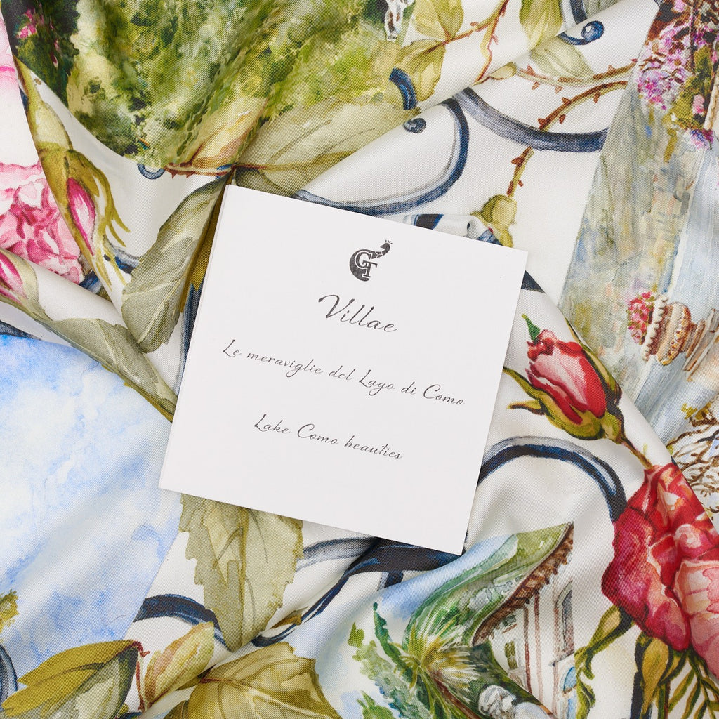 white note about lake Como on top of a colourful silk scarf depicting flowers