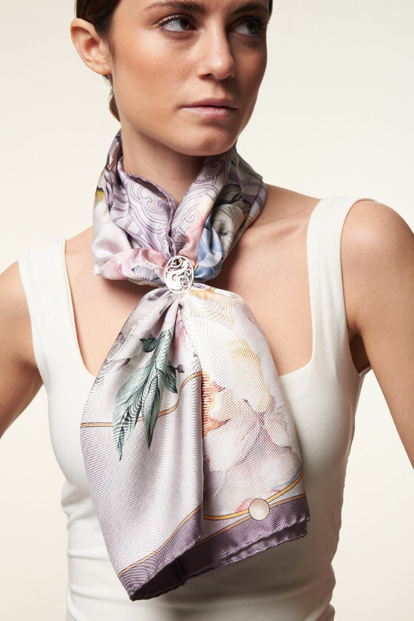 woman wearing white top and purple silk scarf with flowers