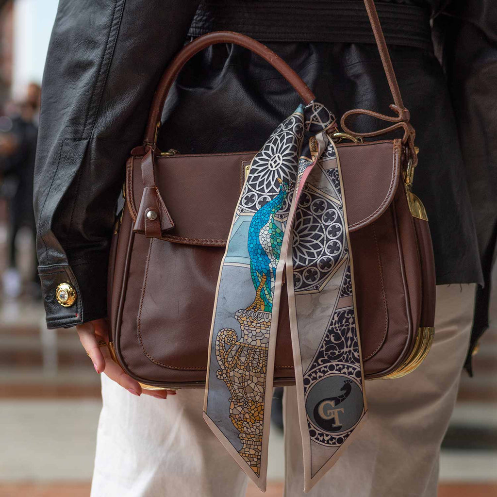 silk twilly on a brown leather bag