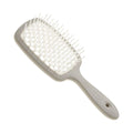 Gray detangling brush on a white background