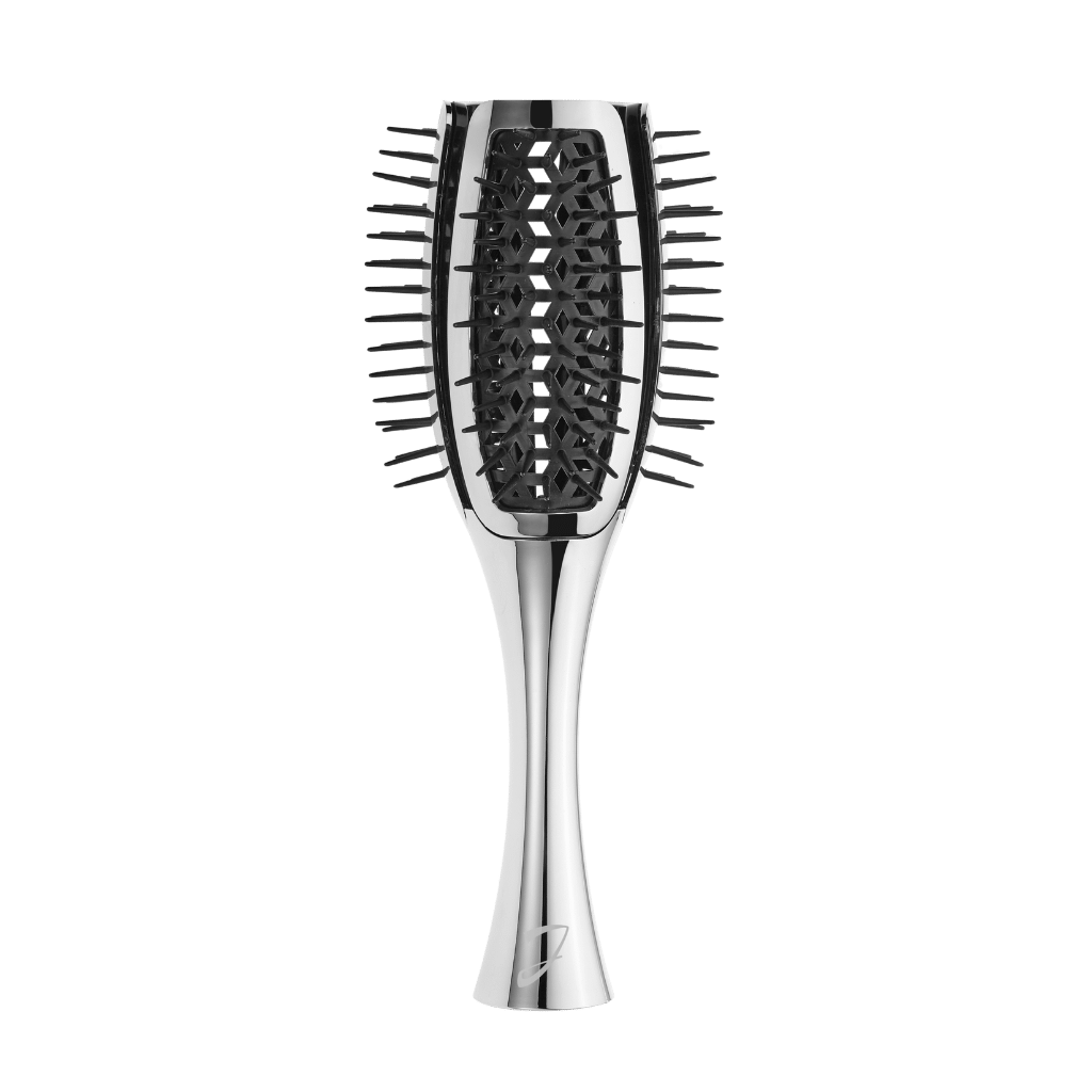 A sleek, metallic silver paddle hairbrush with dark gray bristles, centered against a solid dark green background.