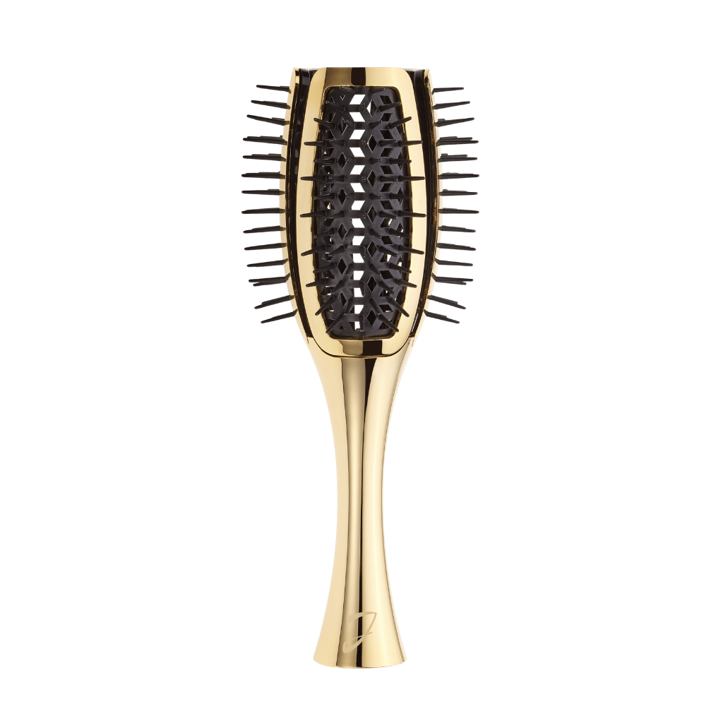 A gold-colored oval hairbrush with black bristles and a black geometric patterned center, shown against a solid white background.