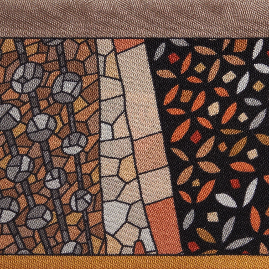 artistic patterns on a gold and orange silk twilly